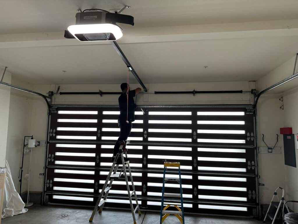 Technician inspecting a garage door to provide an accurate repair cost estimate.